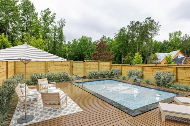 swimming pool view with a seating space