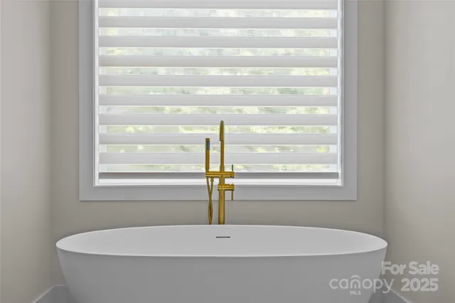 a view of swimming pool with large trees and couches chairs