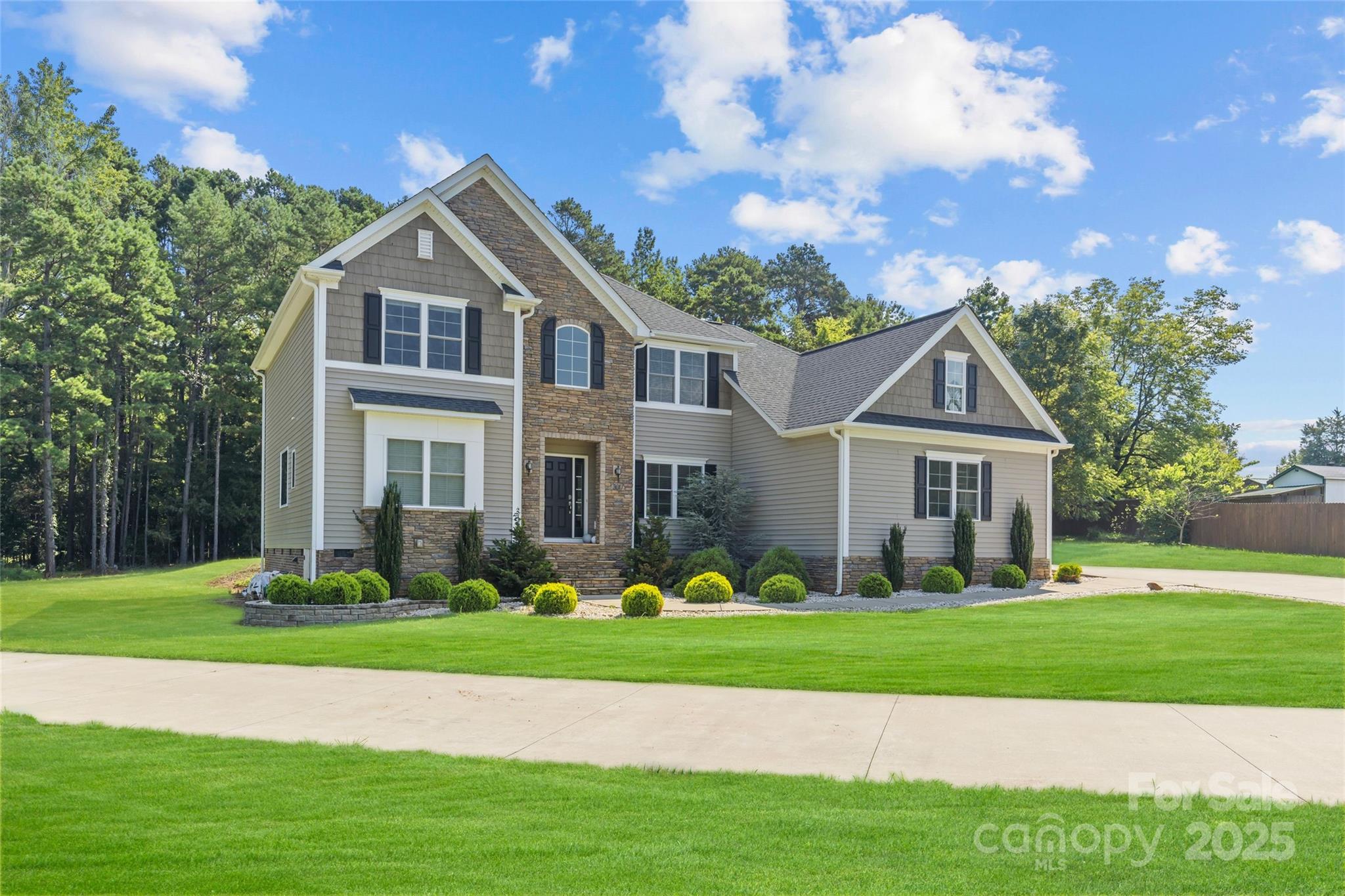 3017 Stevens Schultz Lane Matthews, NC 28104 - Photo 7 of 23 a front view of a house with a yard and trees