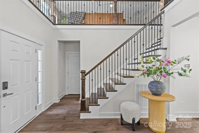 a living room with furniture a fireplace and a chandelier