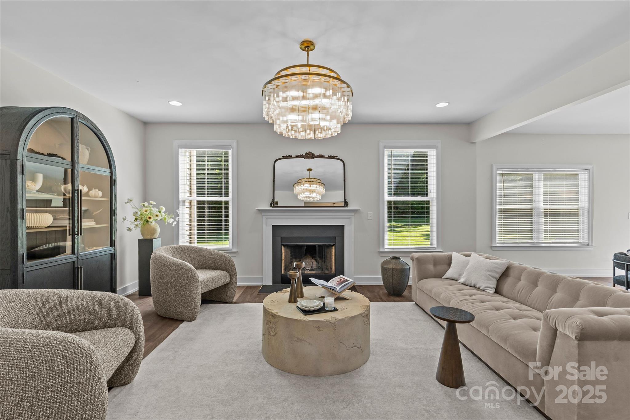 3017 Stevens Schultz Lane Matthews, NC 28104 - Photo 9 of 23 a living room with furniture a fireplace and a chandelier
