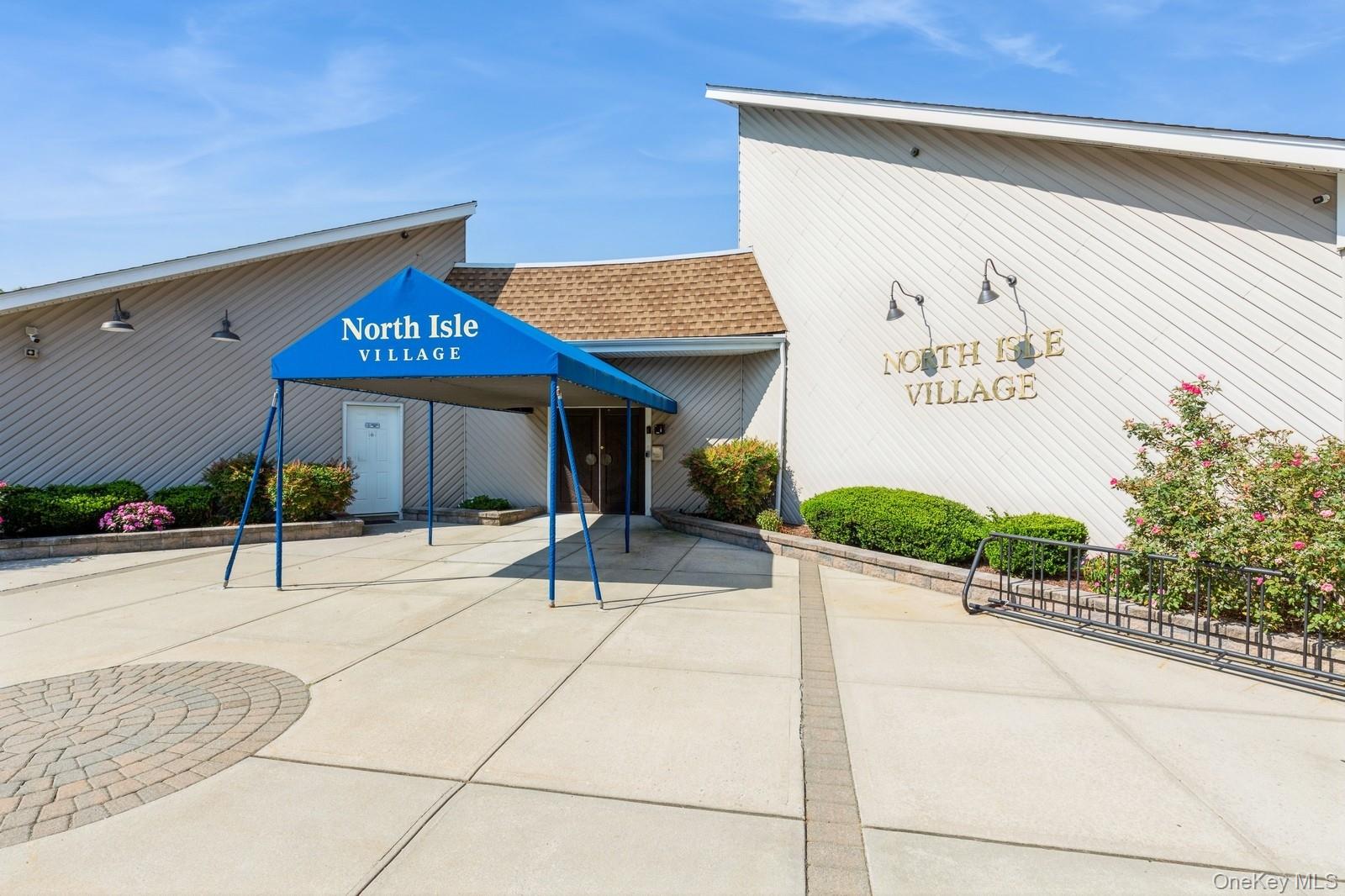 49 Pointe Circle South, Unit 49 Coram, NY 11727 - Photo 9 of 16 a view of a building with a tree