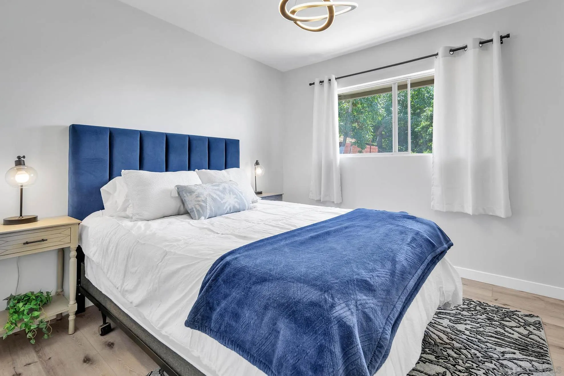 9817 Edgar Place La Mesa, CA 91941 - Photo 23 of 47 a bed sitting in a bedroom next to a window