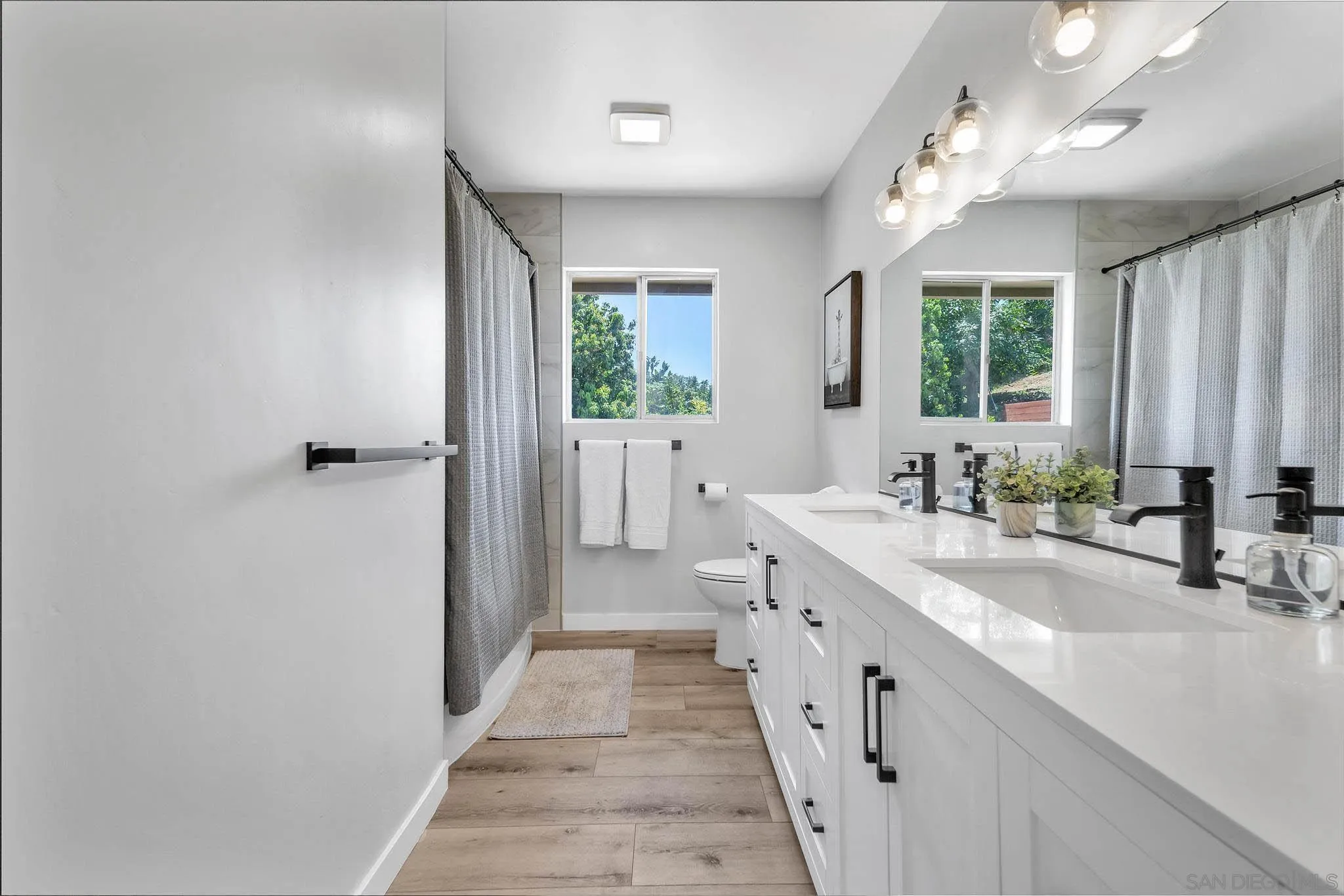 9817 Edgar Place La Mesa, CA 91941 - Photo 24 of 47 a bathroom with a double vanity sink a mirror and a bathtub