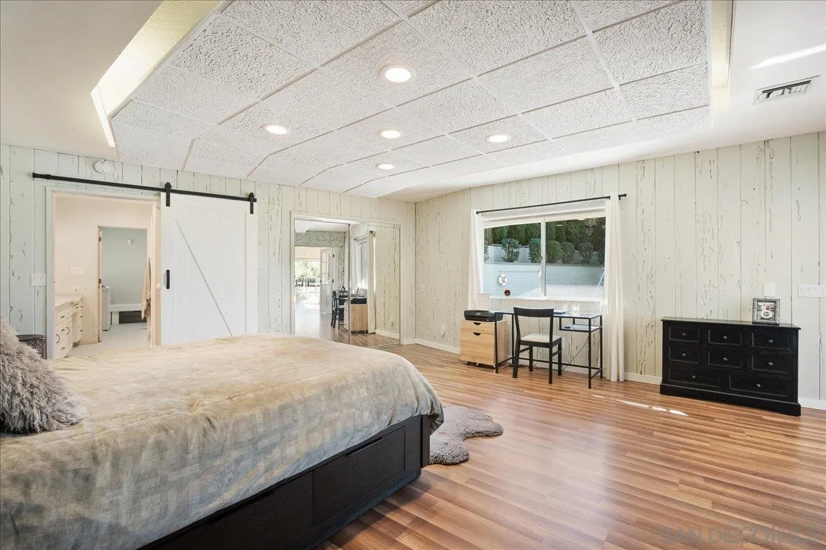 9817 Edgar Place La Mesa, CA 91941 - Photo 40 of 47 a spacious bedroom with a bed and a table in it