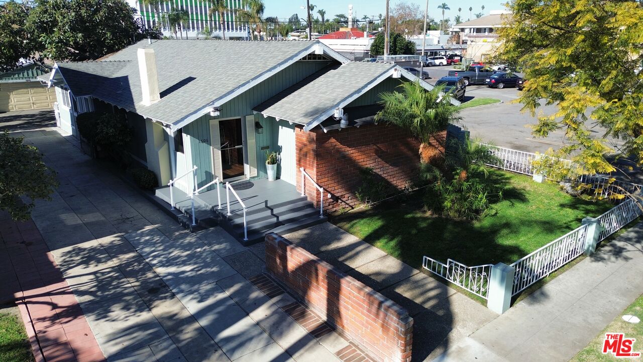 an aerial view of a house with garden space and street view