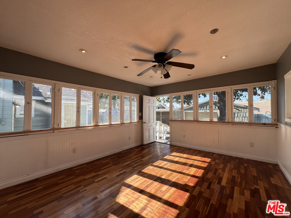 1606 North Bush Street Santa Ana, CA 92706 - Photo 8 of 13 a view of an empty room with wooden floor and a window