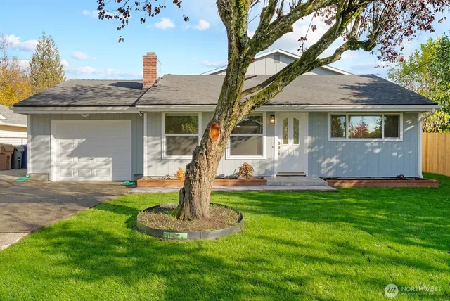a front view of a house with a garden