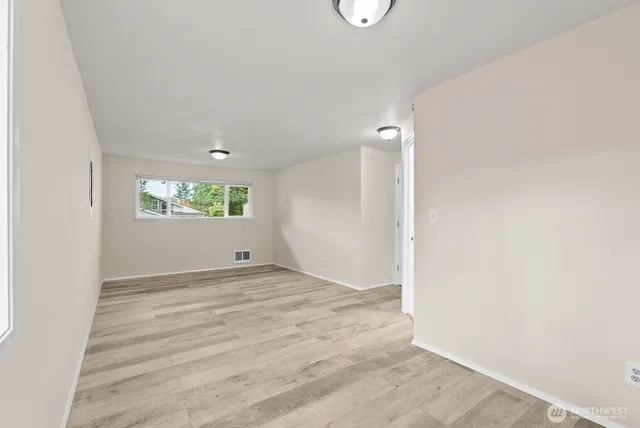 a view of an empty room and a window