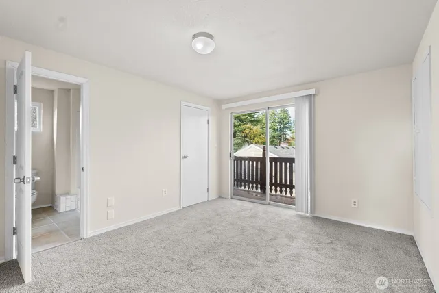 a view of an empty room with glass door