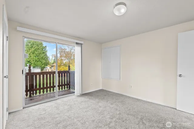 a view of a room with wooden floor and windows