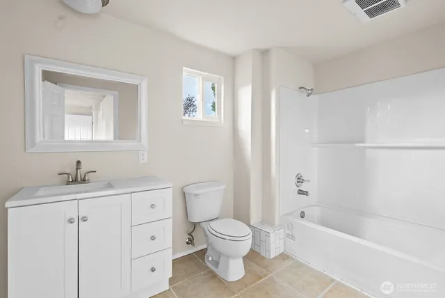 a bathroom with a toilet a sink and bathtub