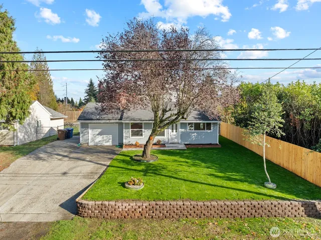 a front view of a house with a yard and garage