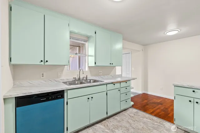 a kitchen with a sink and cabinets