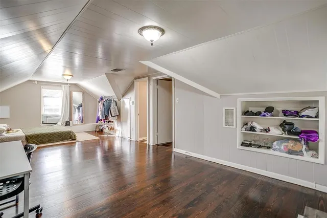 a view of a yard with plants and trees