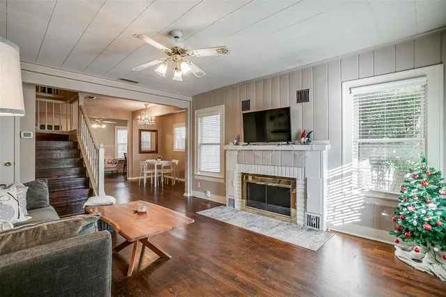 a living room with furniture a fireplace and a flat screen tv