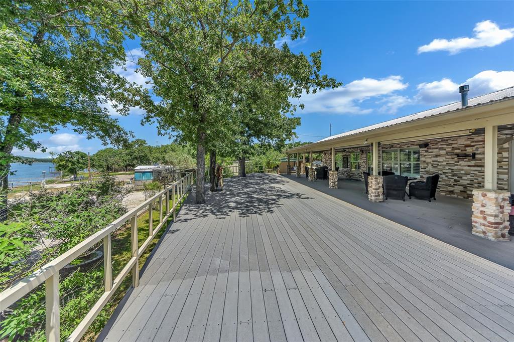 566 Selma Park Road Bowie, TX 76230 - Photo 24 of 40 Expansive outdoor deck with composite decking and a light-colored railing