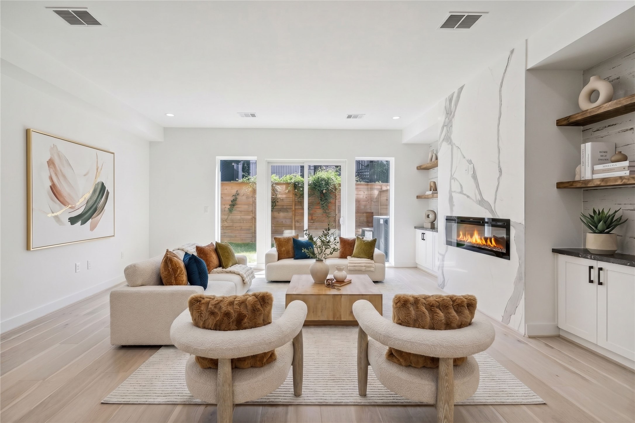 6209 Westcott Street Houston, TX 77007 - Photo 2 of 16 Living Room – Located on the first floor, this inviting space features double French doors opening to the backyard, filling the room with beautiful natural light, along with custom built-ins (virtal staging)