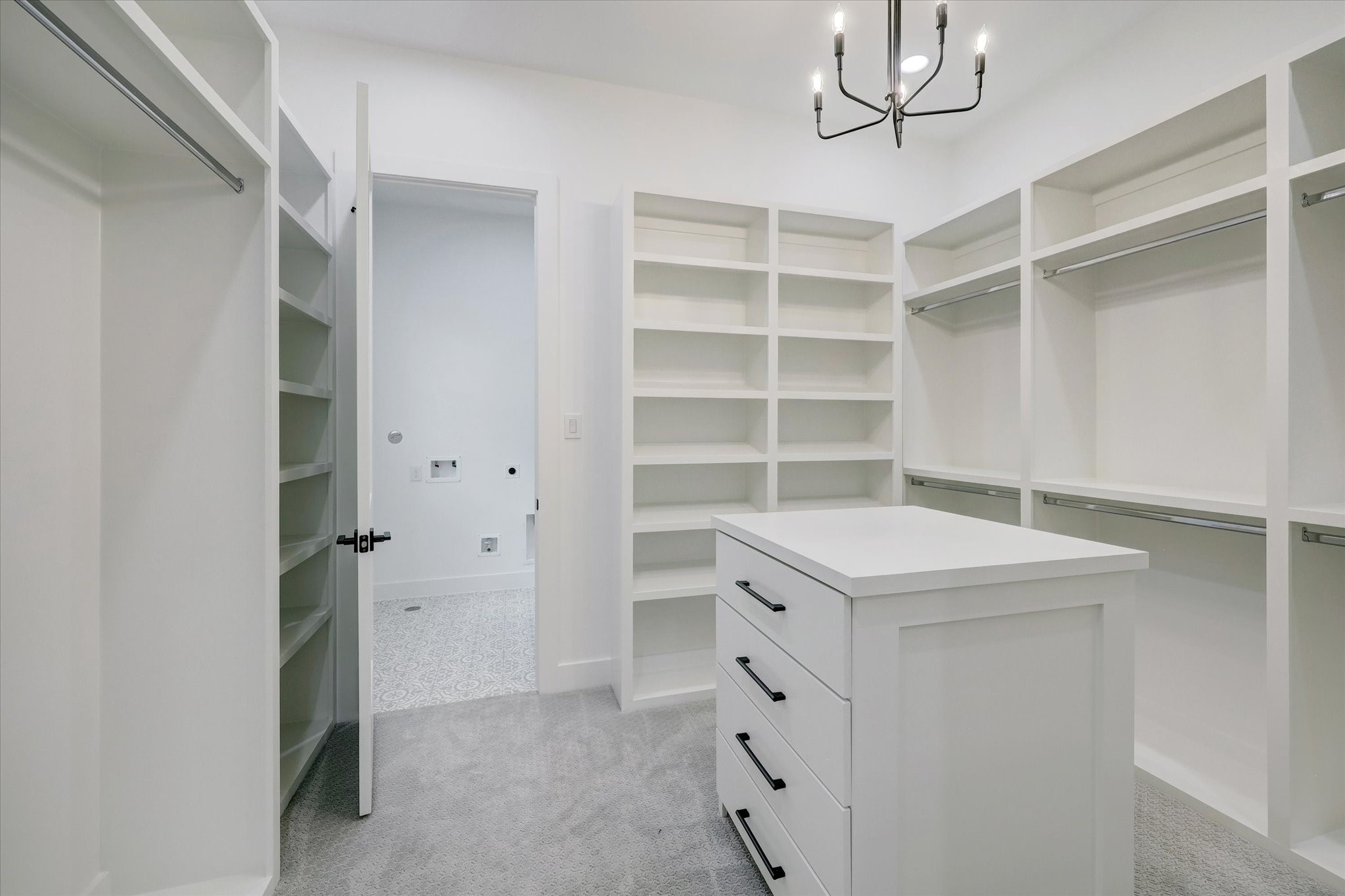 6209 Westcott Street Houston, TX 77007 - Photo 9 of 16 Walk-in Closet (1/2) – Thoughtfully designed with custom built-ins and a center island, offering exceptional storage, organization, and boutique-style functionality.