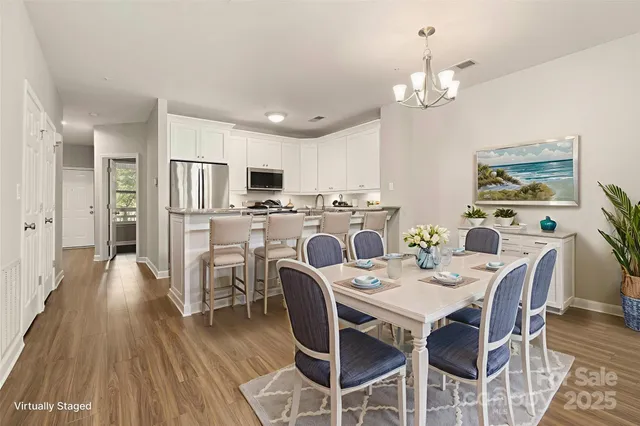 a view of a dining room with furniture and wooden floor