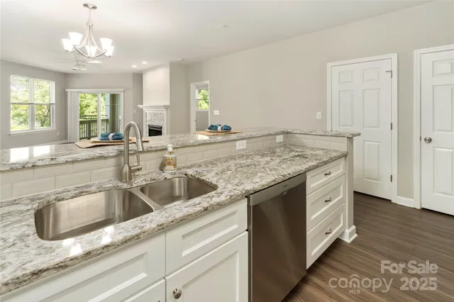 a view of a kitchen counter space a sink and dishwasher