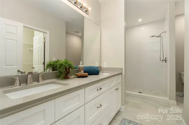 a bathroom with double sink and a mirror