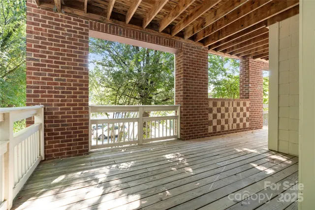 a view of a porch with wooden floor