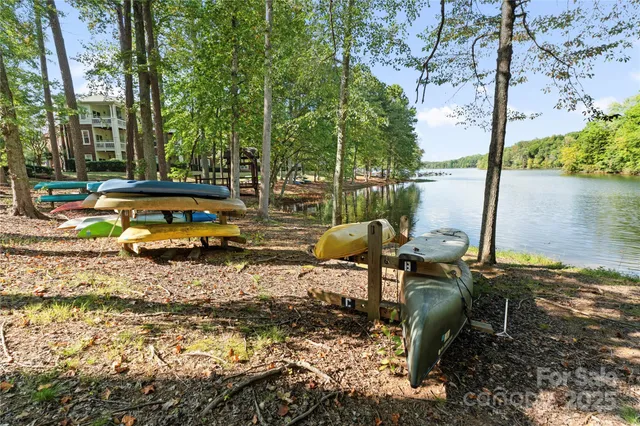 a view of a lake with a bench and trees around