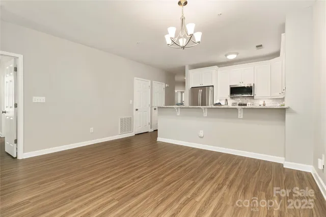 a view of a kitchen with stove and cabinets