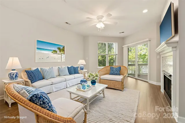 a living room with furniture a large window and a fireplace