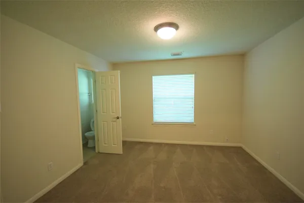 an empty room with a empty space and windows