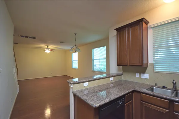 a kitchen with granite countertop a sink and a window