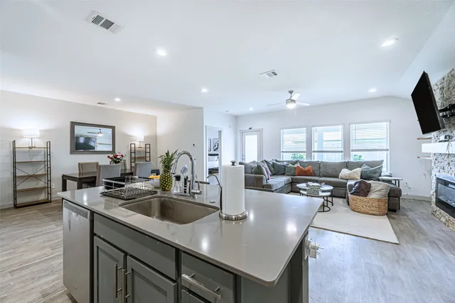 a kitchen with counter space appliances and a living room
