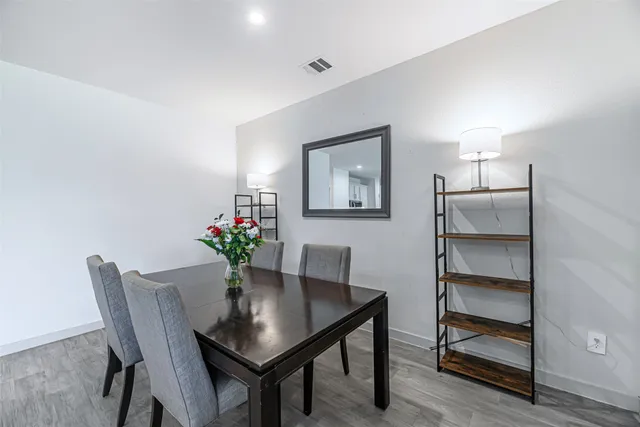 a dining room with furniture and wooden floor