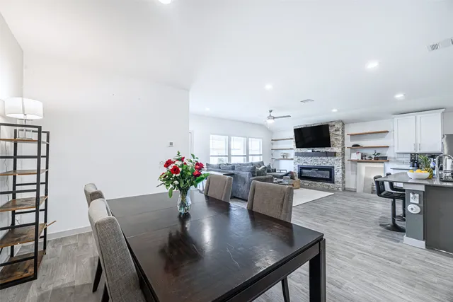 a kitchen with a dining table chairs microwave and cabinets