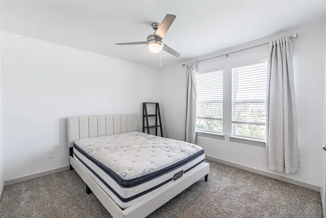 a bed sitting in a room next to a window