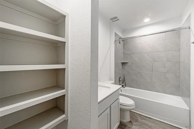 a bathroom with a toilet and a bath tub