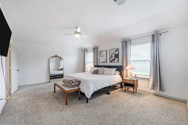 a bedroom with a bed and a window