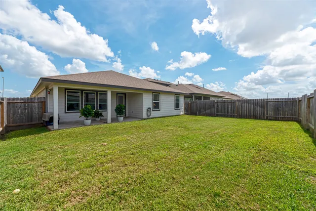 a view of a yard with wooden fence