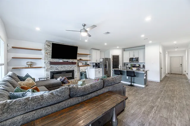 a living room with furniture a fireplace and a flat screen tv