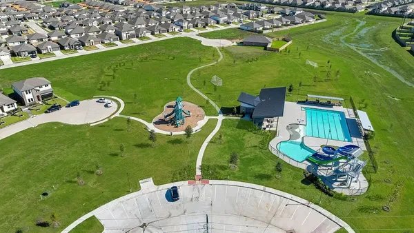 a view of a wooden chairs and fire pit in the backyard