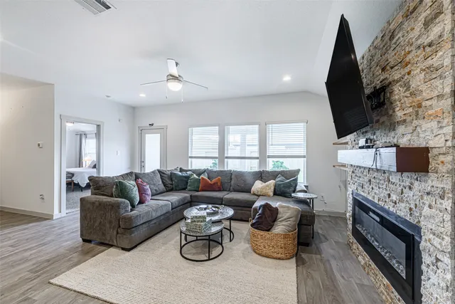 a living room with furniture and a fireplace
