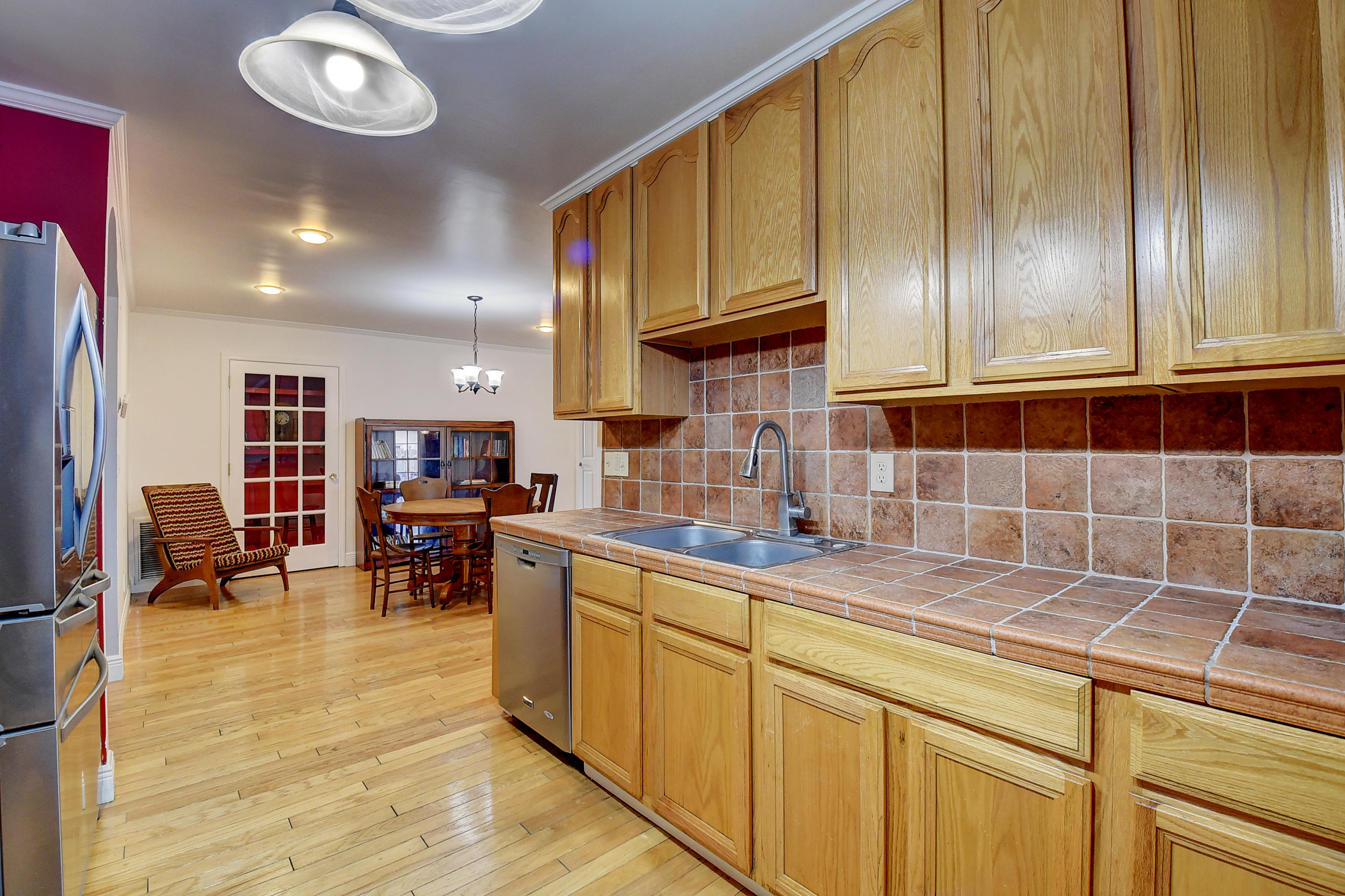 1775 Southwest 8th Street Boca Raton, FL 33486 - Photo 12 of 20 a kitchen with stainless steel appliances granite countertop a sink dishwasher stove and cabinets with wooden floor