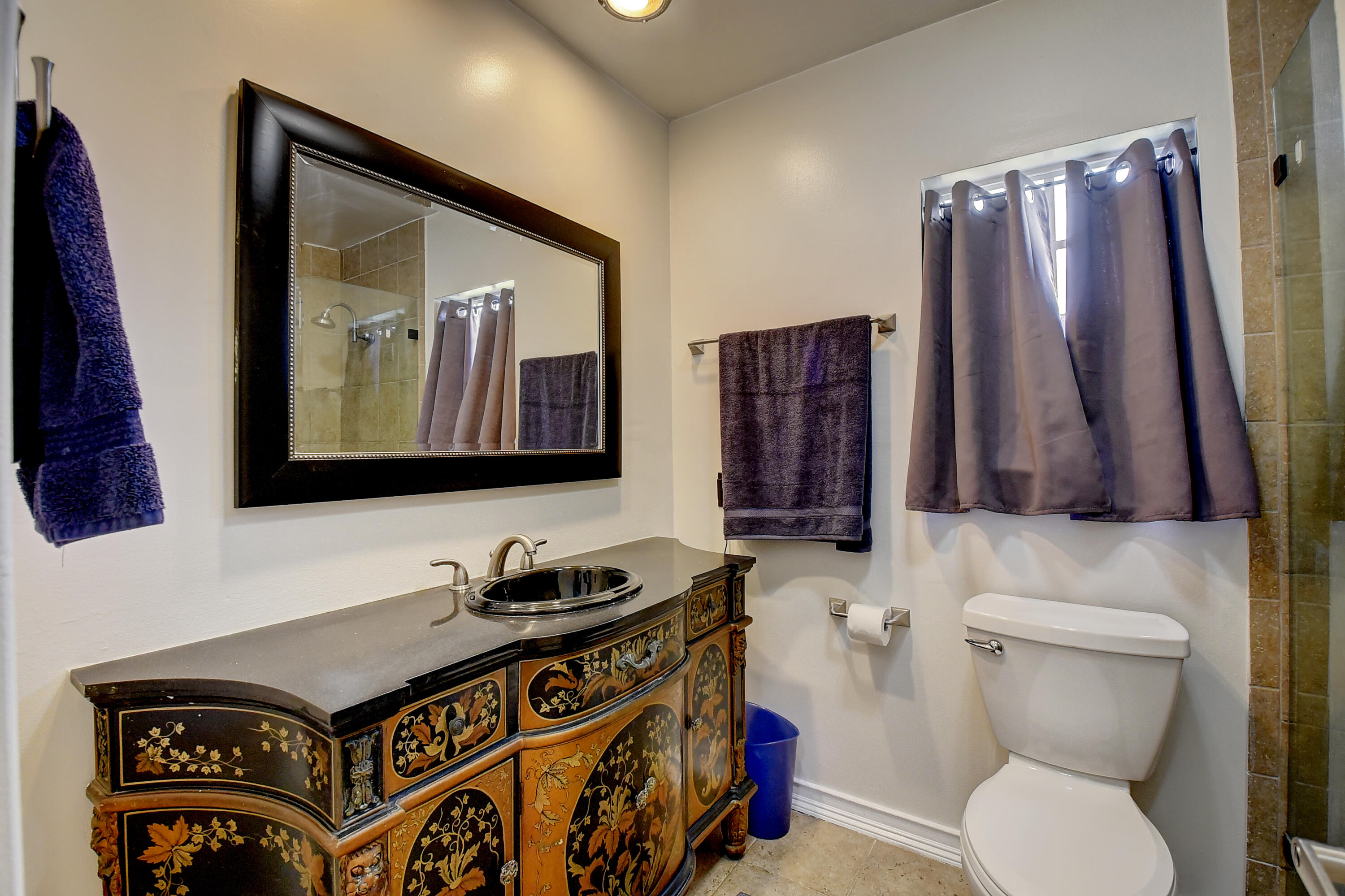 1775 Southwest 8th Street Boca Raton, FL 33486 - Photo 15 of 20 a bathroom with a toilet a sink and a mirror