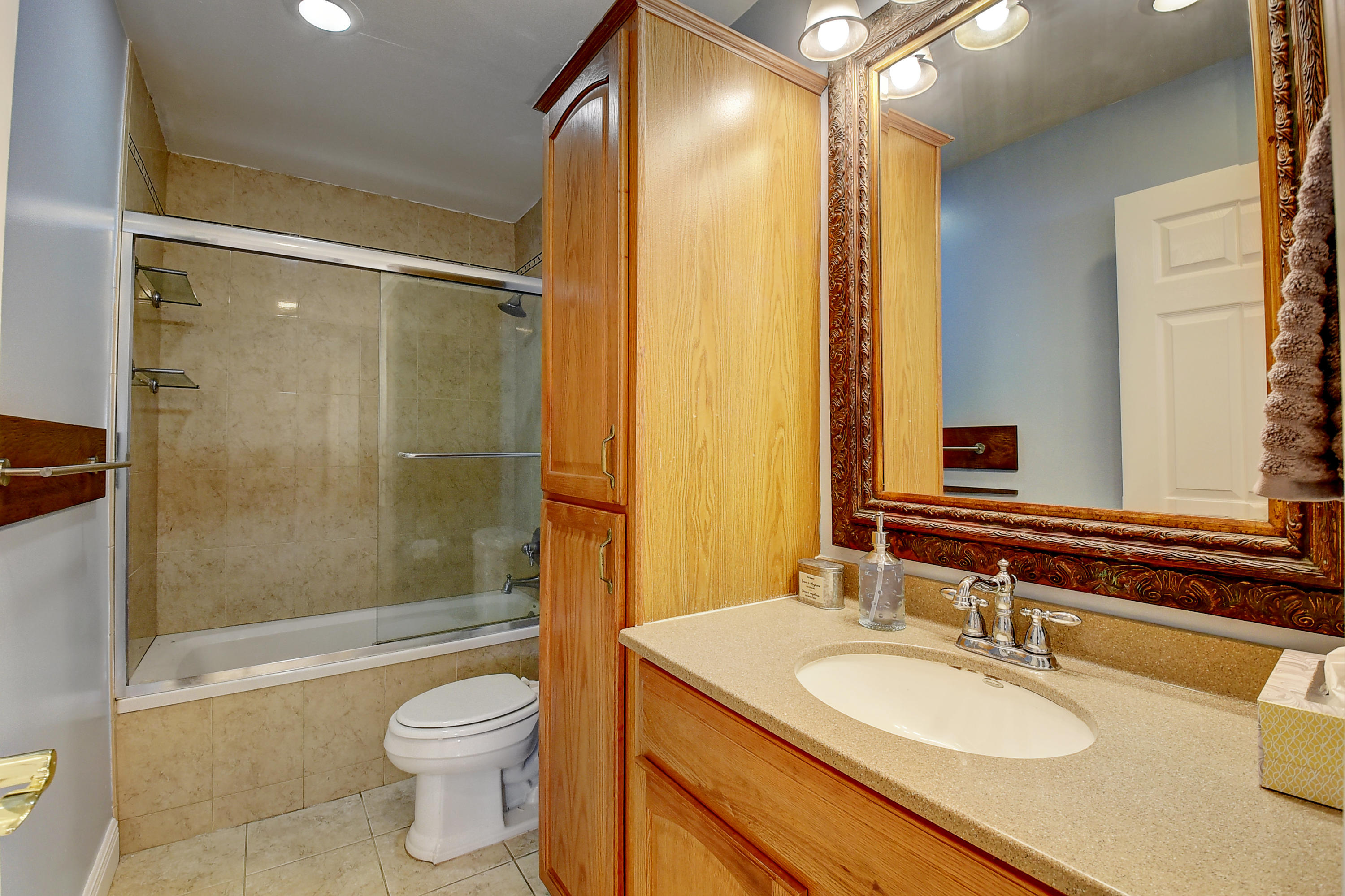 1775 Southwest 8th Street Boca Raton, FL 33486 - Photo 19 of 20 a bathroom with a sink a toilet and shower