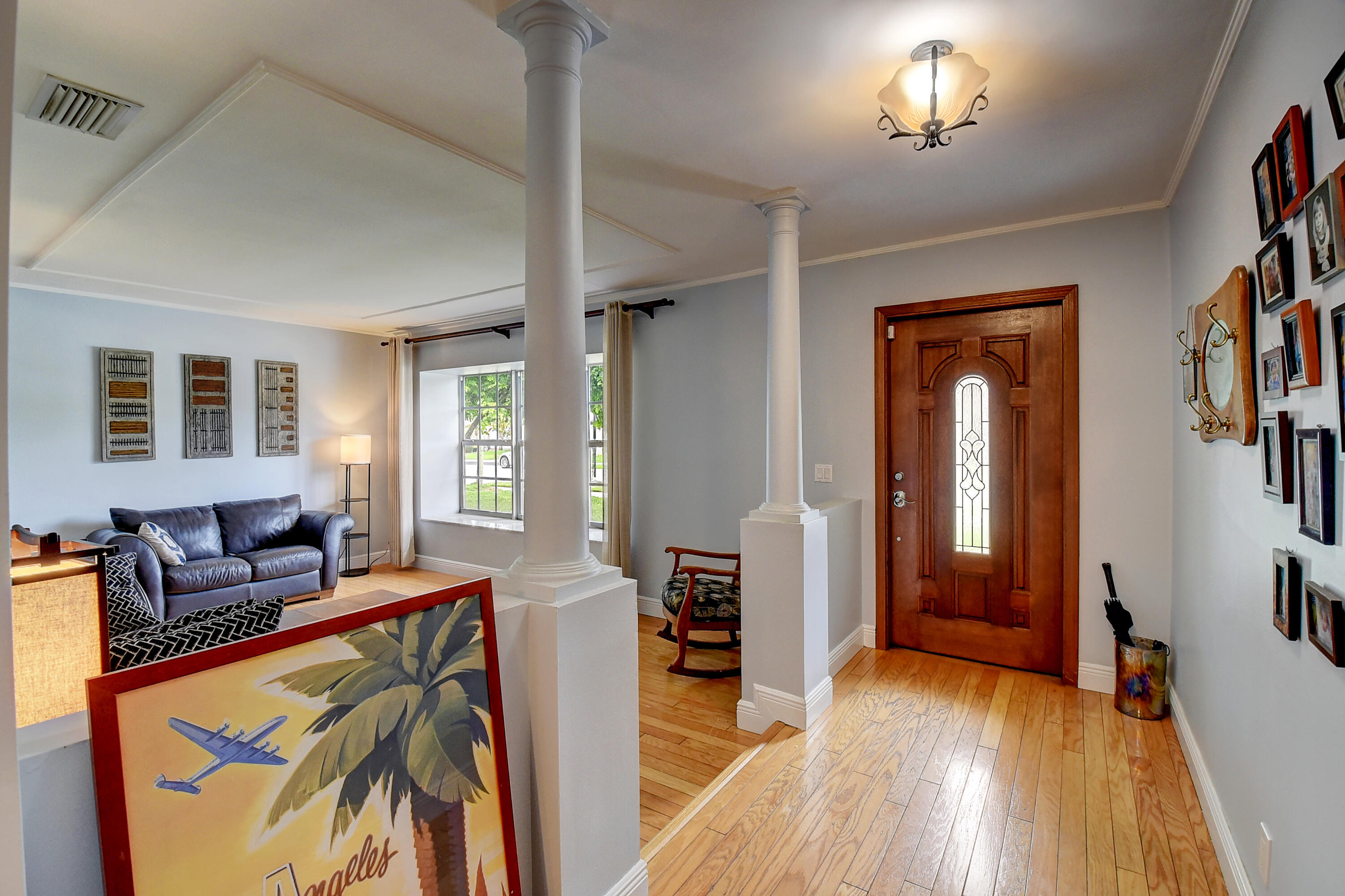 1775 Southwest 8th Street Boca Raton, FL 33486 - Photo 3 of 20 a view of a livingroom with furniture hardwood floor and a flat screen tv