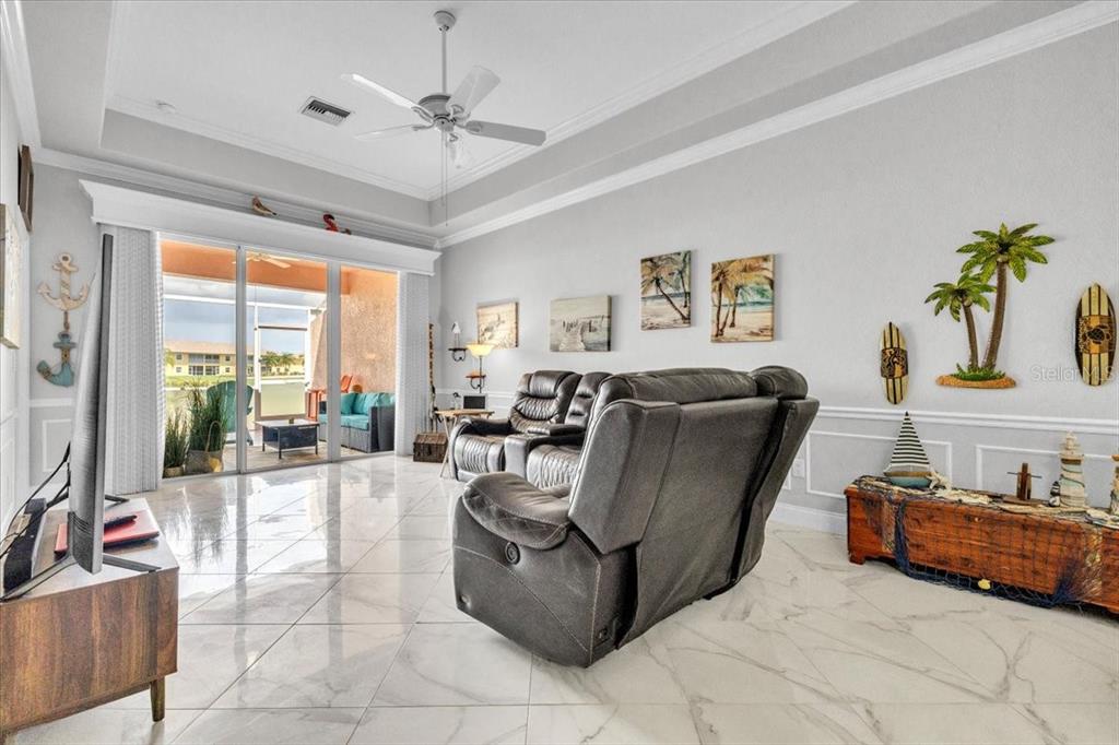 1260 Rio De Janeiro Avenue, Unit 102 Punta Gorda, FL 33983 - Photo 7 of 46 a living room with furniture and a floor to ceiling window