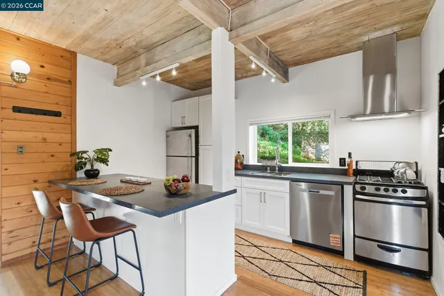 a kitchen with a stove a sink and cabinets