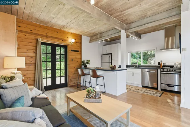 a living room with furniture and a kitchen area