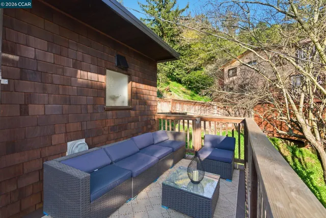 a view of deck with furniture and a backyard